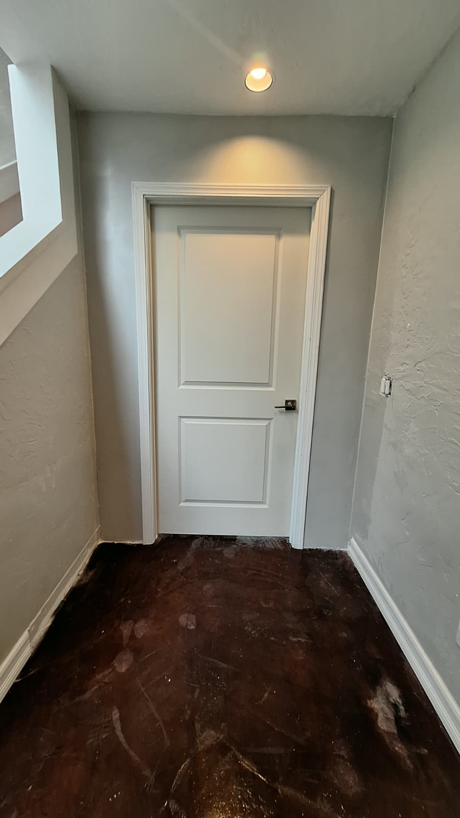 Interior hallway with dark brown floors before the work