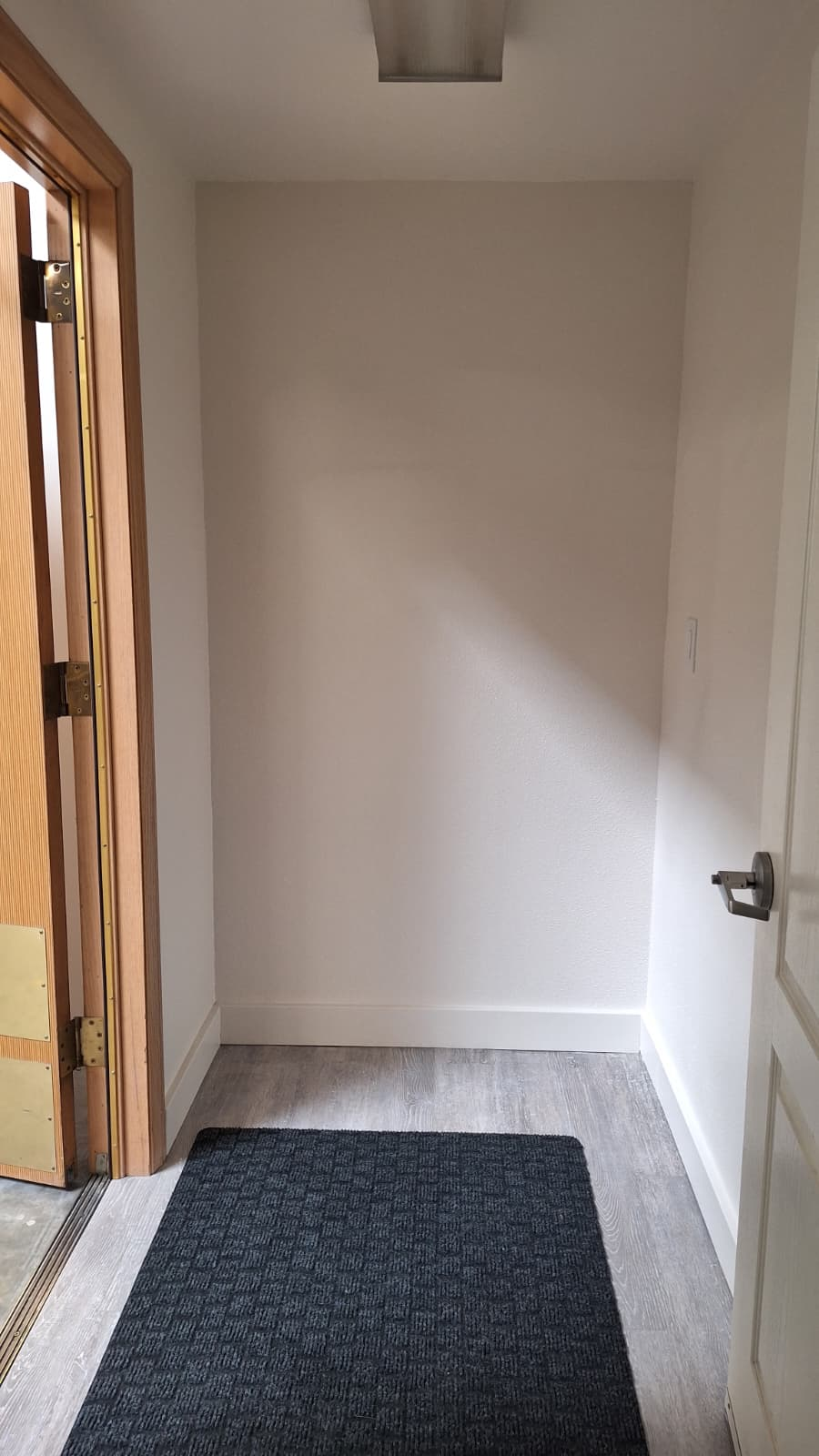 Same hallway with finished drywall and flooring