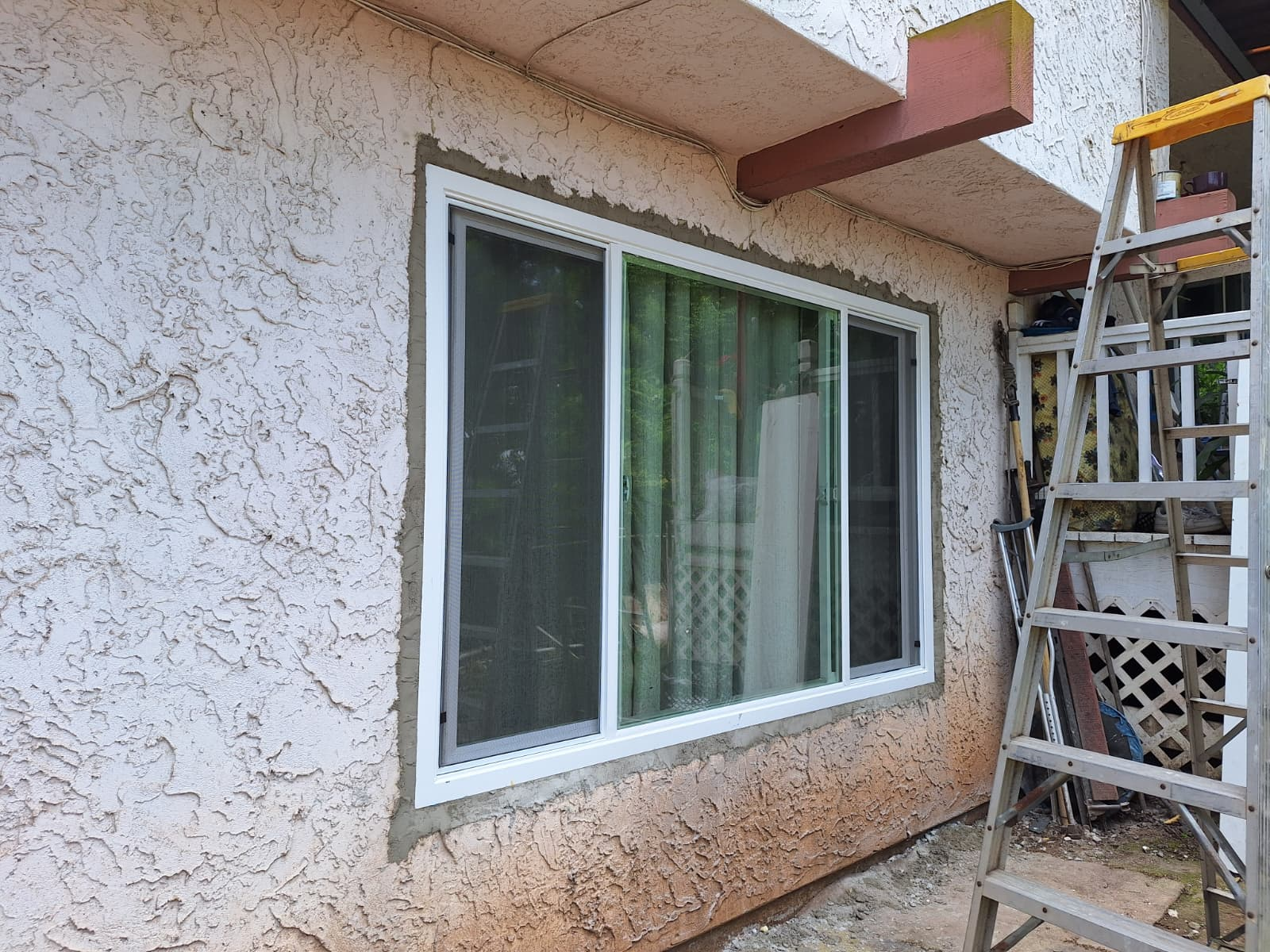 New sliding window installed in the exterior stucco wall