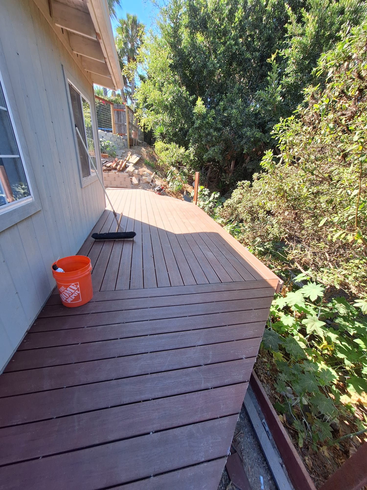 Brown deck surface beside the house